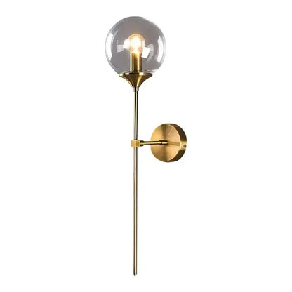 Brass finished sconce light with amber decorbites glass ball and exposed bulb, ideal for bedroom wall decor