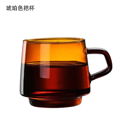 Amber-colored glass coffee mug with handle filled halfway with dark liquid by decorbites glass coffee mug