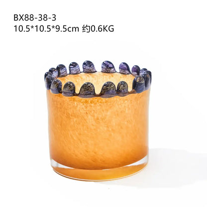 Amber glass cylinder vase with textured orange glass, ornate black beaded rim, and colored lace purple accents for decor