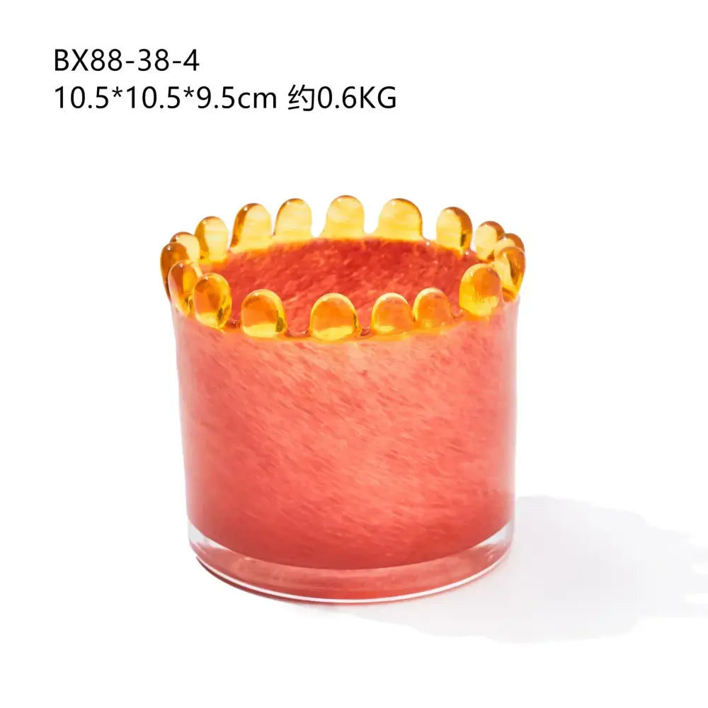 A translucent coral-colored glass cylinder vase with an amber glass bead rim for living room decor