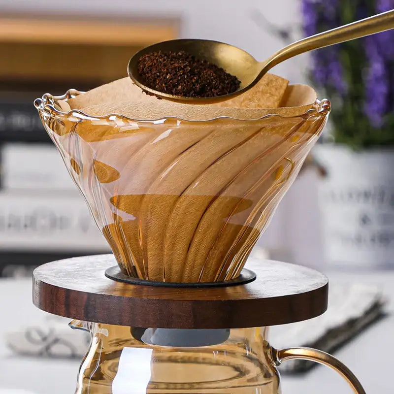 Translucent amber glass coffee filter pot with fluted wavy design and black rubber seal for pour over brewing