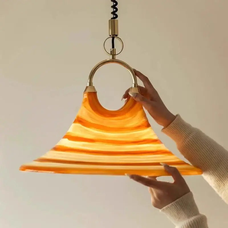 Amber glass liftable trumpet chandelier with warm flared layered design and brass hardware for dining room decorbites liftable