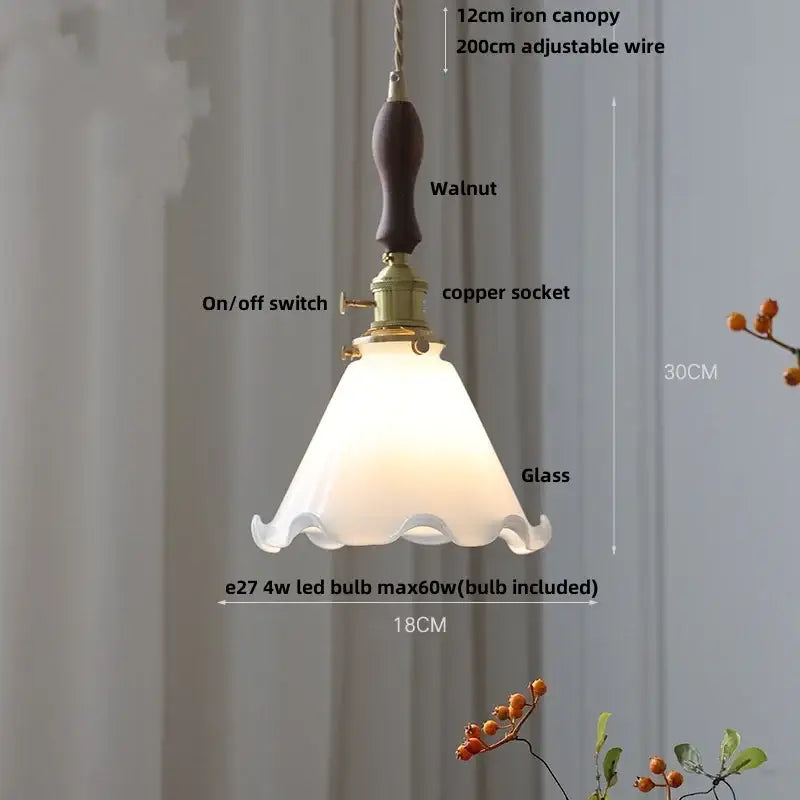 Amber glass pendant light with a frosted scalloped edge and brass knob switch for dining room decorbites brass knob