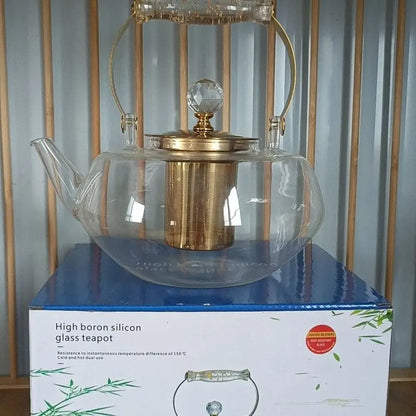 Clear glass teapot with gold-toned metal lid handle infuser and faceted crystal knob decorbites amber glass teapot