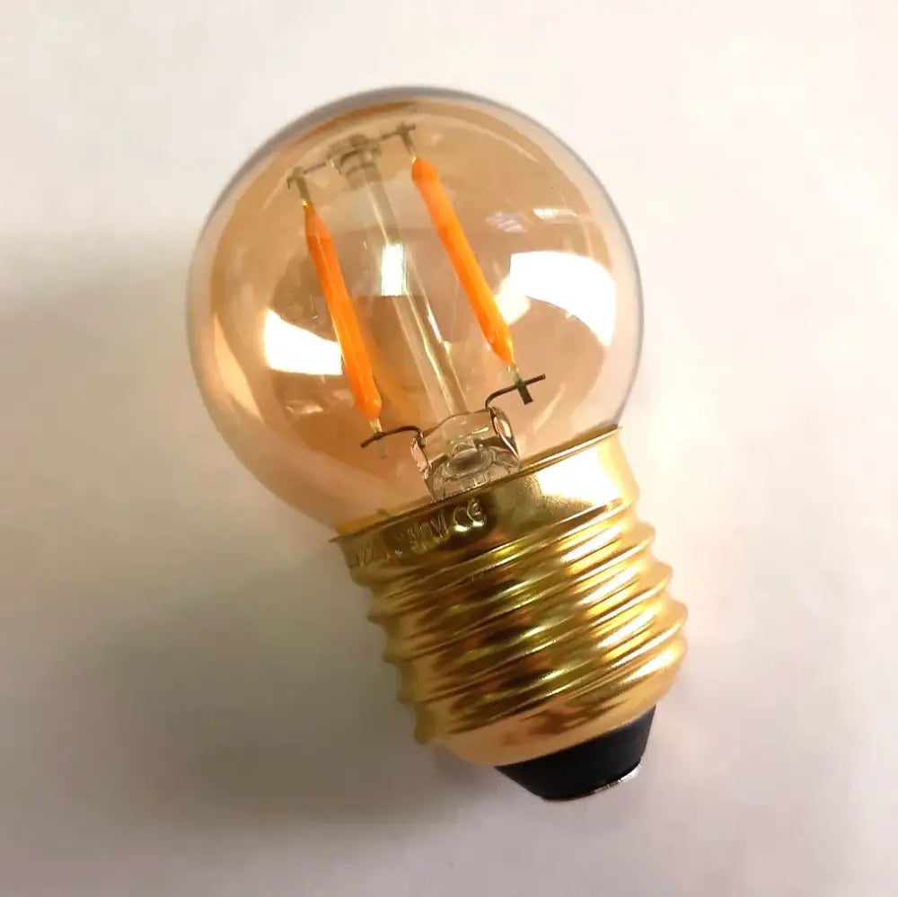 Warm-toned decorbites amber glass vintage led bulb with brass screw base and glowing orange filaments for bedroom use