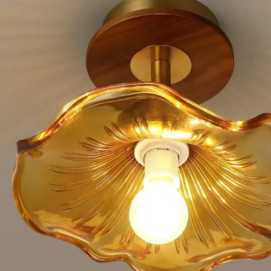 Golden glass shell ceiling light with wood copper led base and brass accents for dining room illumination