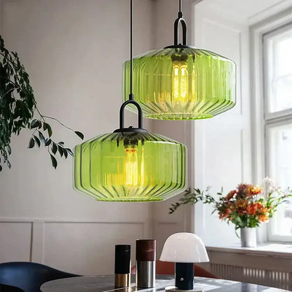 Two green ribbed glass led pendant chandelier lights with black metal fixtures for kitchen lighting