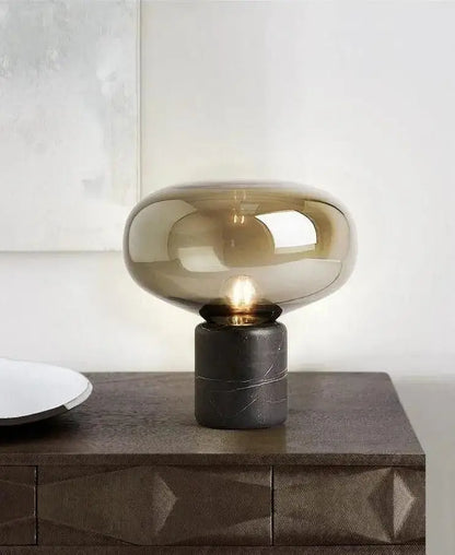 Amber nordic table lamp with a sleek amber-tinted glass shade and matte black marble base for modern table lighting