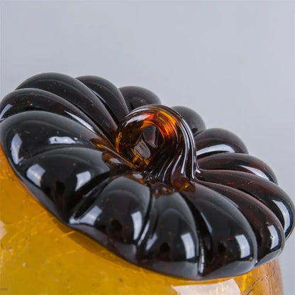 Glossy black glass hazelnut pinecone ornament with amber stem on yellow base for decorbites glass hazelnut decor