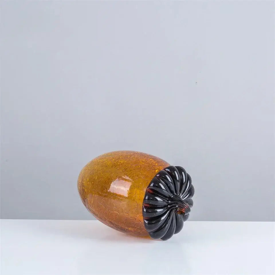 Translucent amber glass hazelnut pinecone ornament with glossy black ridged cap for living room decor by decorbites