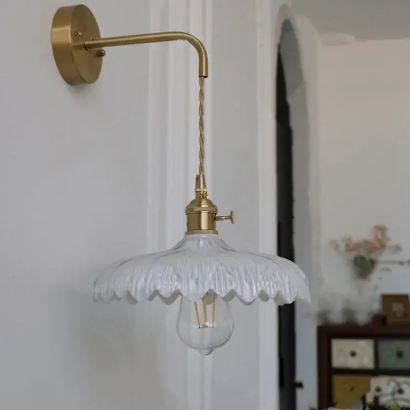 A delicate white glass wall light with scalloped shade and brass pull chain from decorbites amber vintage led collection