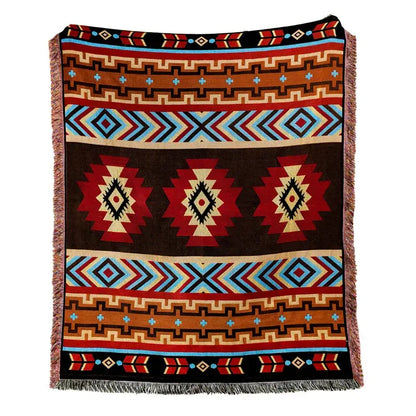A woven american country plaid blanket sofa cover with bold red blue brown and black geometric patterns and fringed edges