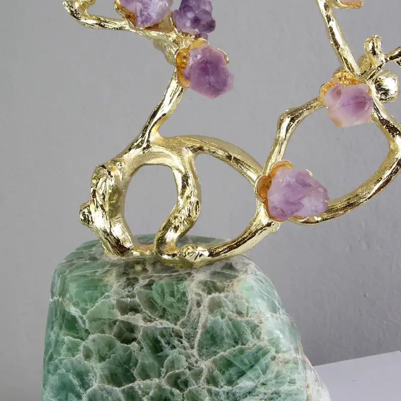 Golden brass tree ornament adorned with raw amethyst crystals on green and white aventurine stone base