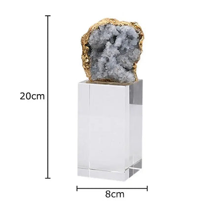 A striking amethyst crystal base geode with gray crystals and golden rim displayed as a desk ornament on acrylic pedestal