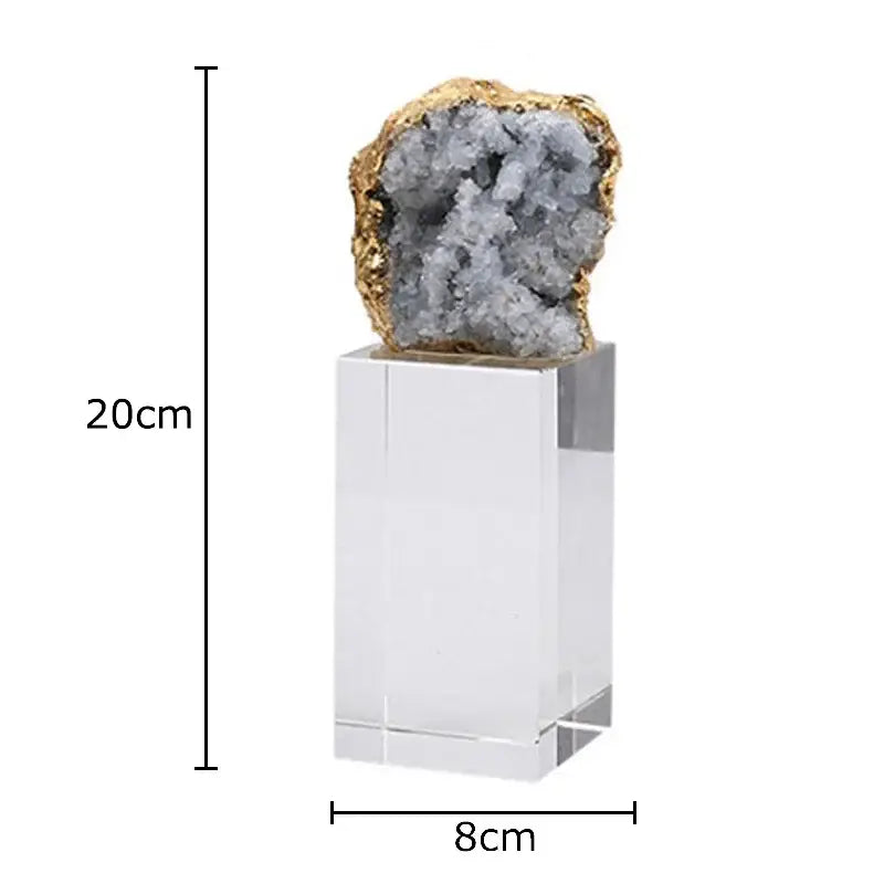 A striking amethyst crystal base geode with gray crystals and golden rim displayed as a desk ornament on acrylic pedestal