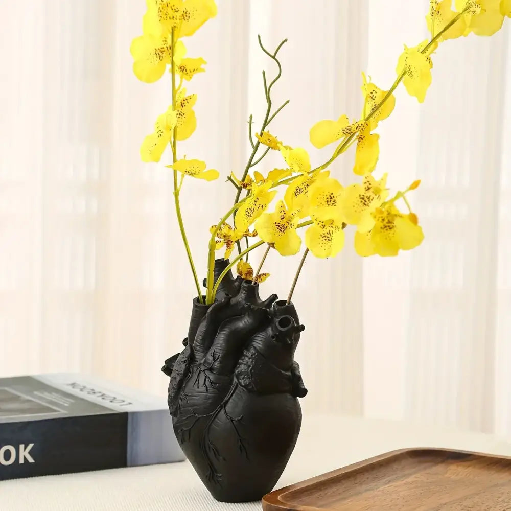 Black anatomical heart resin vase with yellow orchids in decorbites anatomical heart vase for glam decor