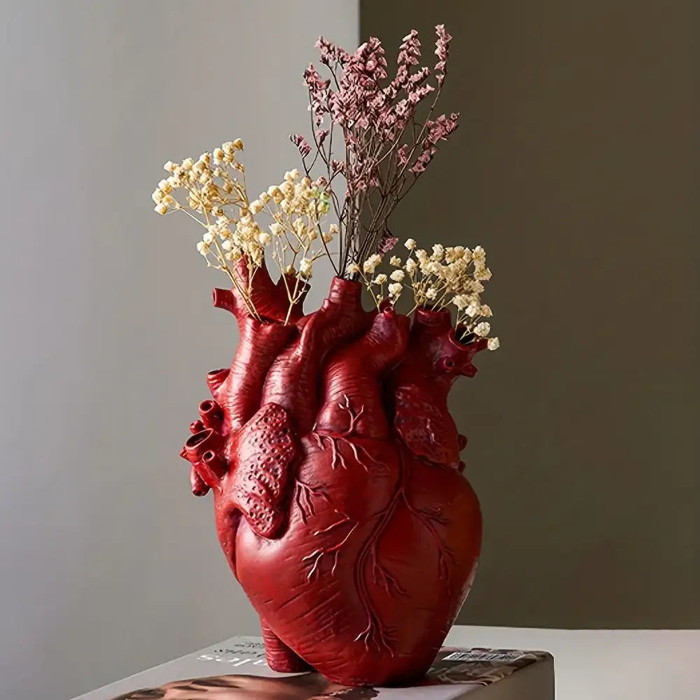 Detailed red anatomical heart resin vase with textured vein patterns holding dried flowers from decorbites glam decor