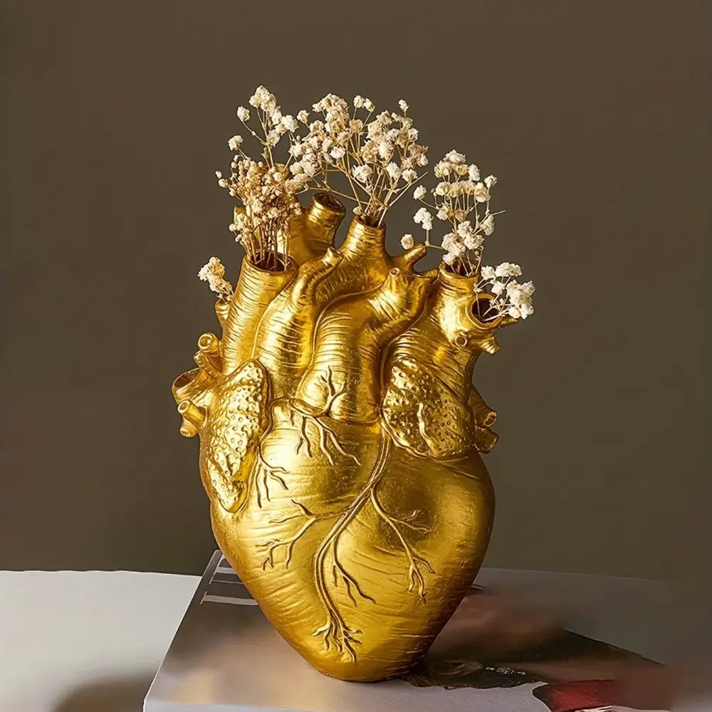 Golden anatomical heart resin vase with intricate vein details holding dried babys breath flowers by DecorBites™