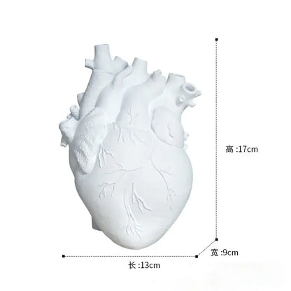 Anatomical white ceramic heart shape vase with detailed ridges and vascular patterns for living room decorbites heart shape