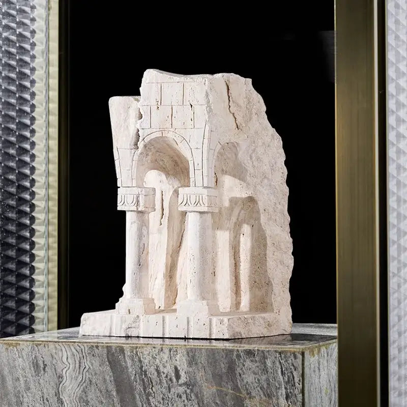 White stone bookend shaped like an ancient greek roman temple with arched openings and fluted columns for home decor