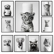 Black and white framed bathroom wall art featuring a cute animal canvas of a tiger cub with toilet paper on its head