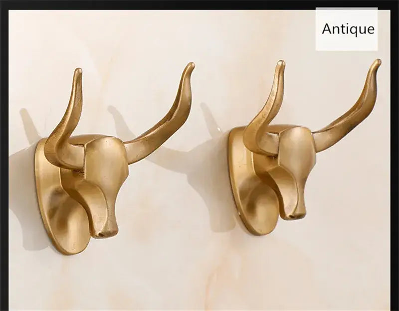 Antique aluminum robe hook featuring a gold-toned bull head with curved horns and polished metallic finish decorbites antique aluminum