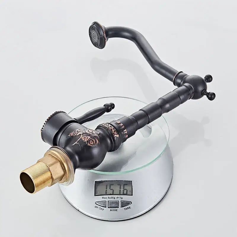 Antique black flower carved basin mixer tap with ornate rose design and gold-colored threaded connection for bathroom use