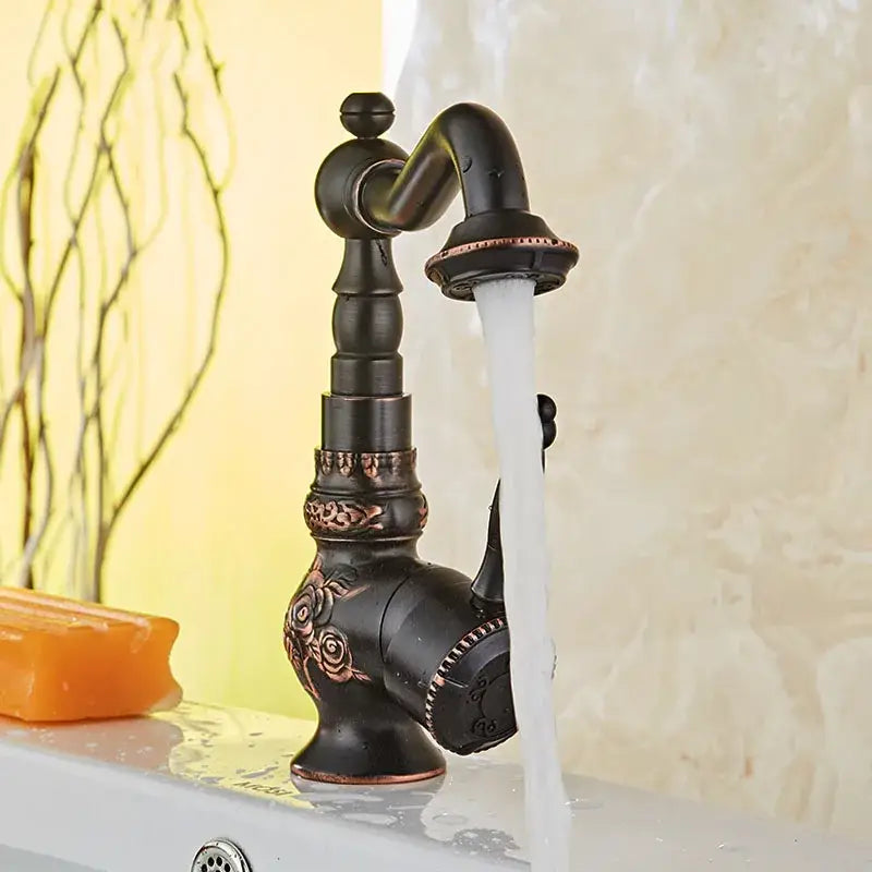 Antique black basin mixer tap with bronze finish, ornate rose and scrollwork detailing, copper accents, and swivel spout