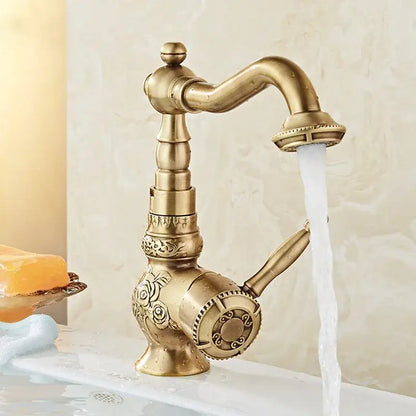 Antique black flower carved basin mixer tap with brass finish, ornate floral detailing, curved swivel spout and side spray nozzle