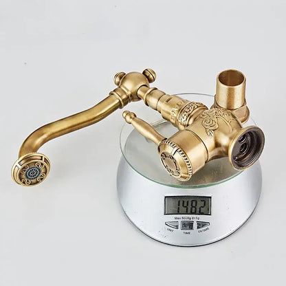 Antique black brass basin mixer tap with ornate rose engraving and curved swivel spout for bathroom basins