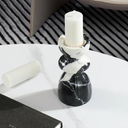 Black and white marble candlestick holder with sleek twisted design holding tall ribbed white pillar candle decorbites grand antique