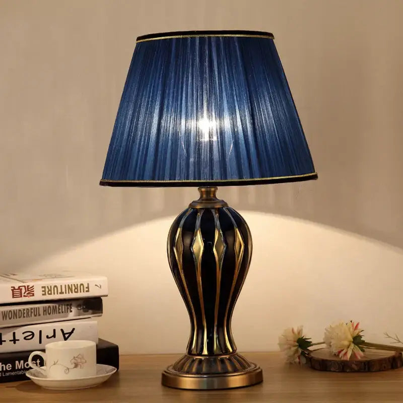 Antique blue ceramic desk lamp with elegant navy pleated lampshade and gold trimmed black brass striped base