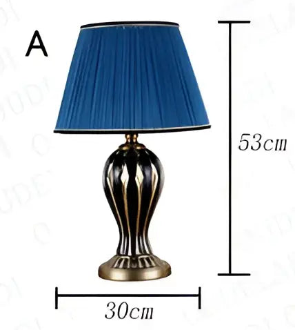 Antique blue ceramic desk lamp with blue pleated lampshade and gold accented dark ornate brass base for bedroom use