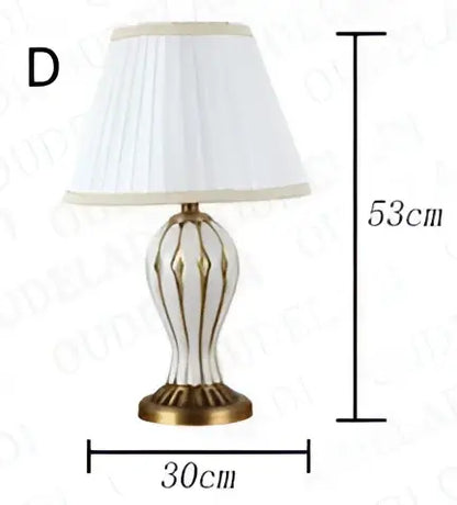 Antique blue ceramic table lamp with fluted glass body gold accents and white pleated fabric shade for bedroom use