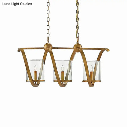Gold-toned wrought iron chandelier with three clear glass candle holders and matching chains in antique brass for dining room