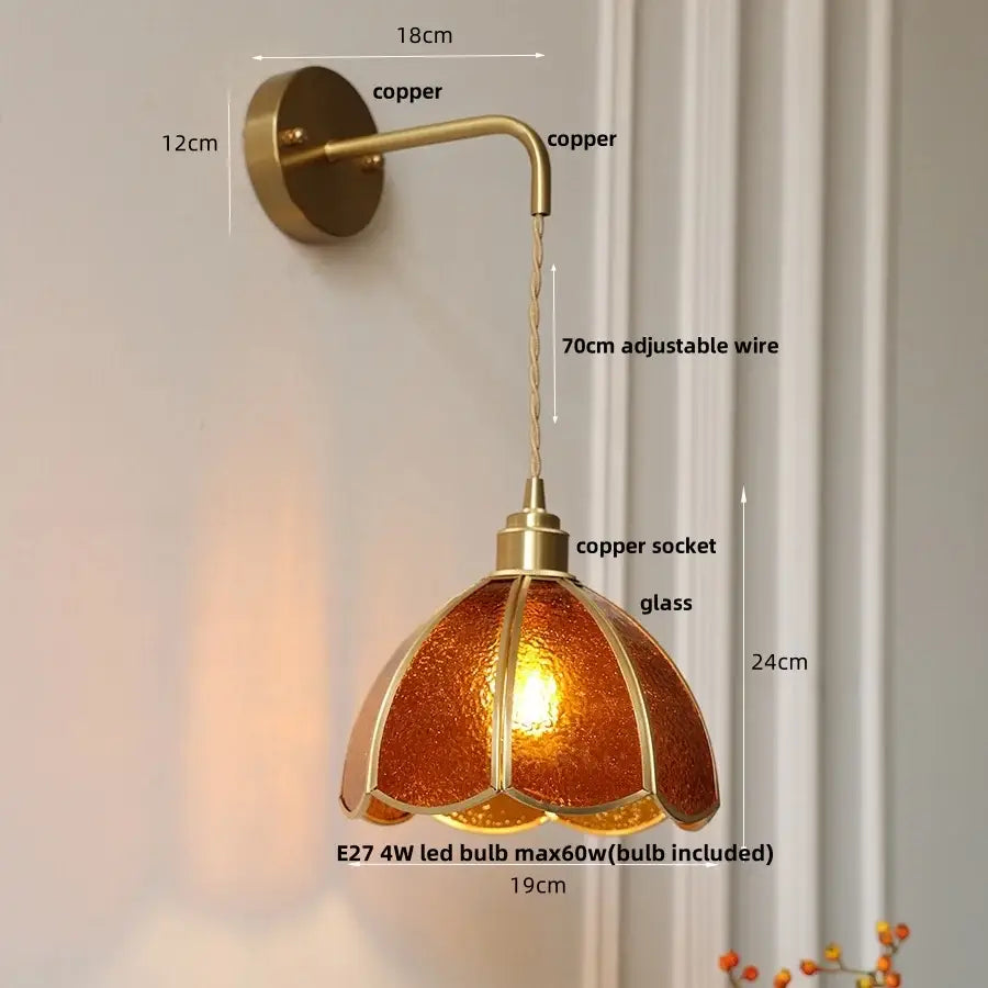 Antique brass amber glass led wall light featuring a textured open flower shade perfect for bedroom decorbites wall light