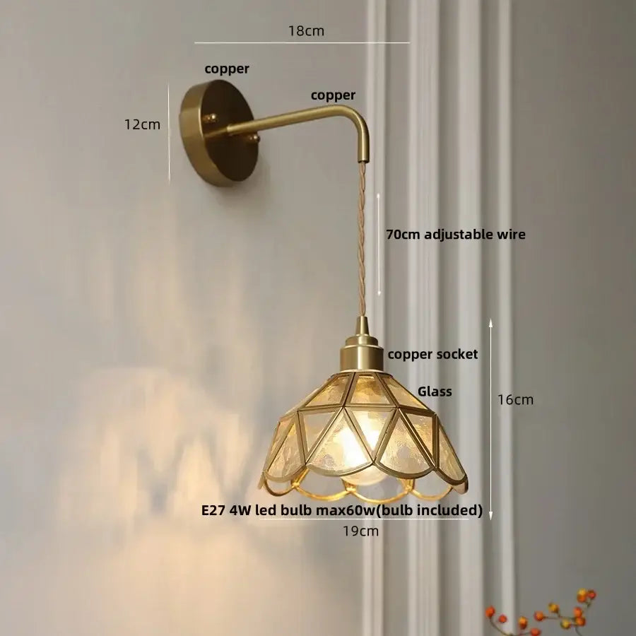 Brass-finished wall light with decorbites amber glass led shade and adjustable copper wire arm for bedroom sconce