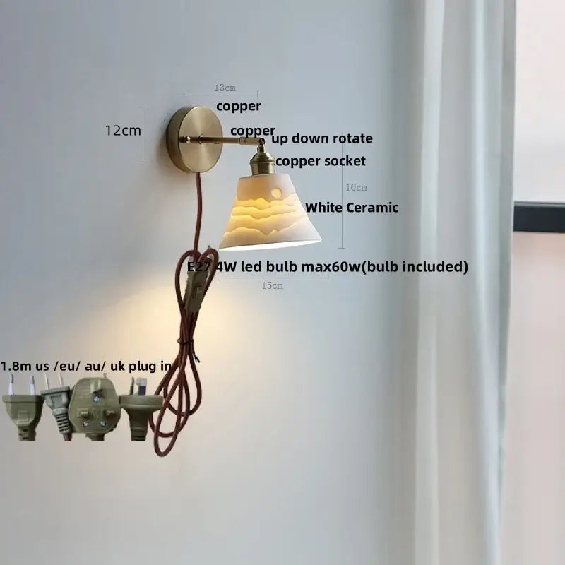 Antique brass and amber glass wall light with a white ceramic led wall shade featuring a subtle sun design decorbites ceramic led