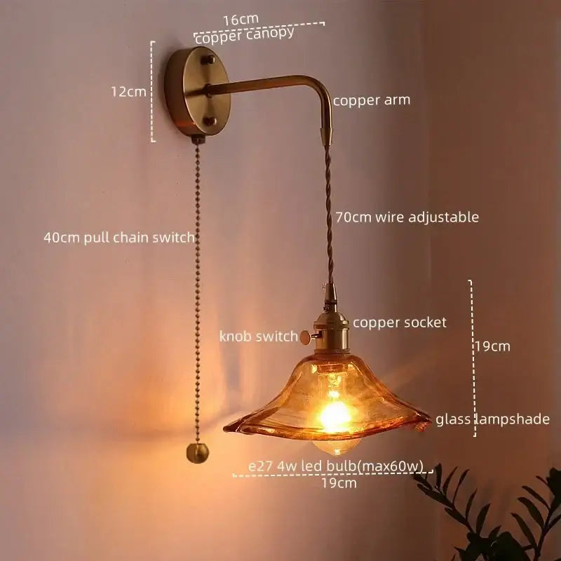 Copper led wall light with amber glass shade and adjustable arm ideal for bedroom lighting with antique brass finish