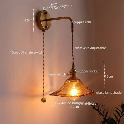 Copper led wall light with amber glass shade and adjustable arm ideal for bedroom lighting with antique brass finish