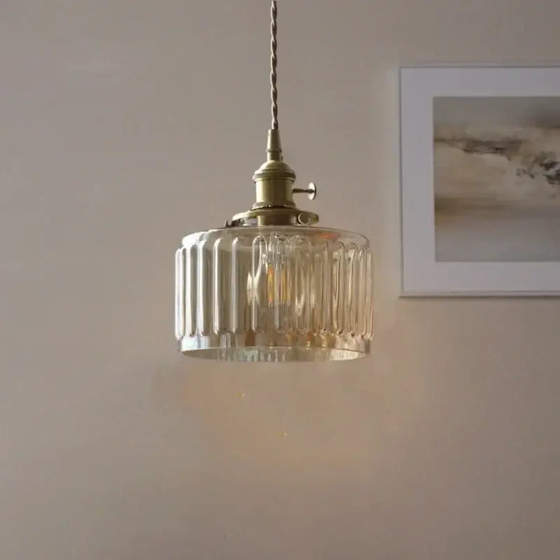Antique brass pendant light with clear ribbed amber glass led shade and brass hardware for stair hanging use
