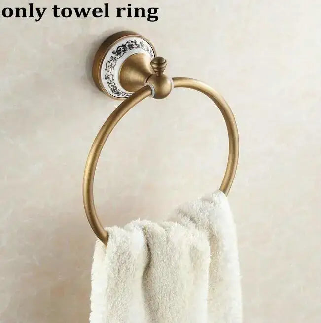 Antique brass towel ring with decorative white ceramic backplate featuring black floral patterns in decorbites bathroom accessories set