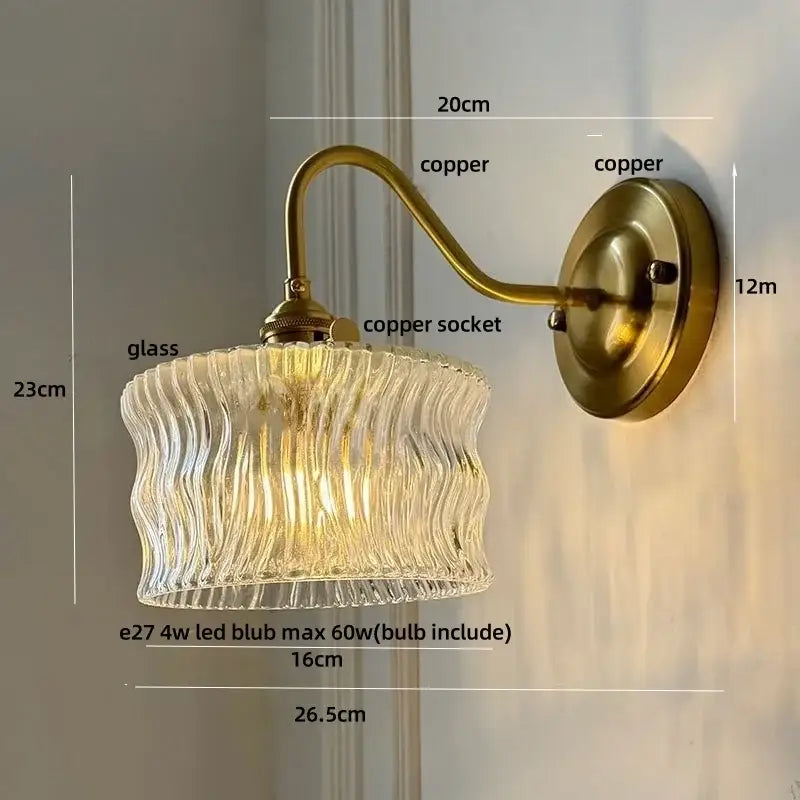 Antique brass wall sconce with clear glass wavy shade for bedroom light featuring decorbites clear glass design