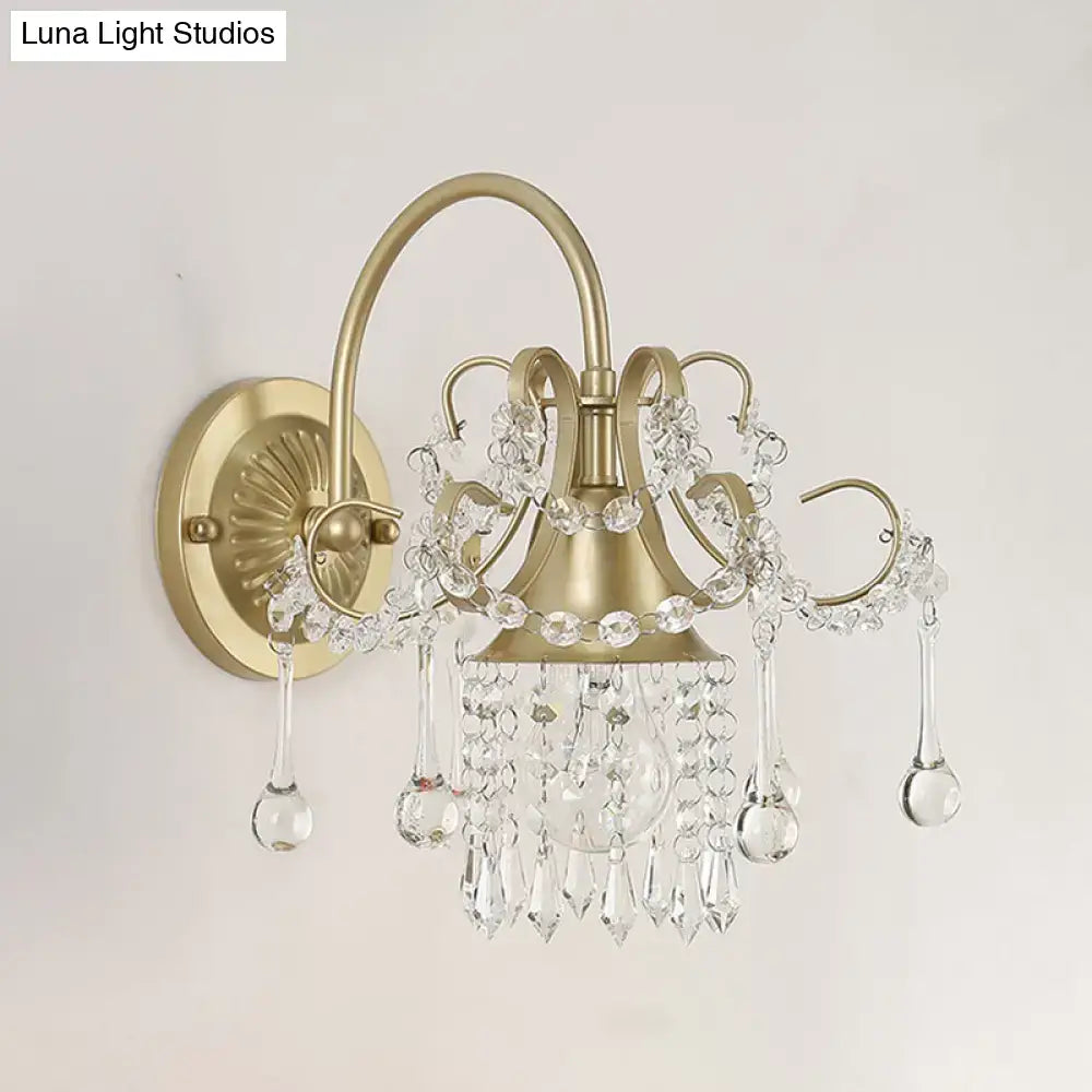 Antique brass and crystal teardrop wall light sconce with cascading crystal droplets for elegant bedroom lighting