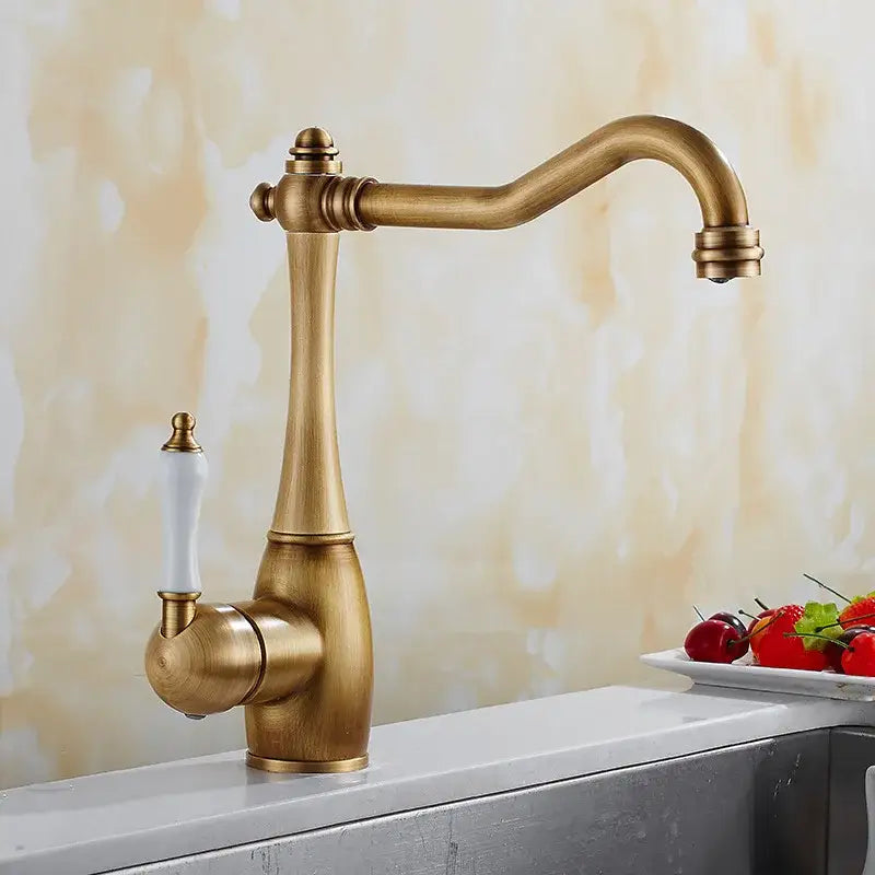 Antique brass and white ceramic kitchen faucet with elegant curved spout and swivel mixer for precise control