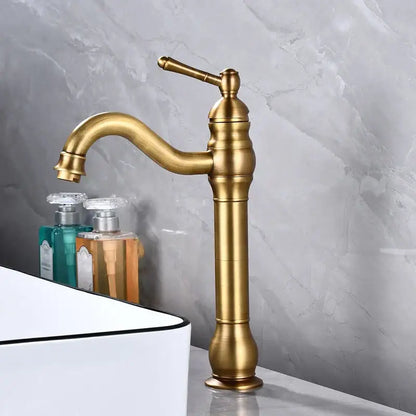 Antique brass basin faucet with single handle and curved spout featuring a vintage decorbites brass basin design