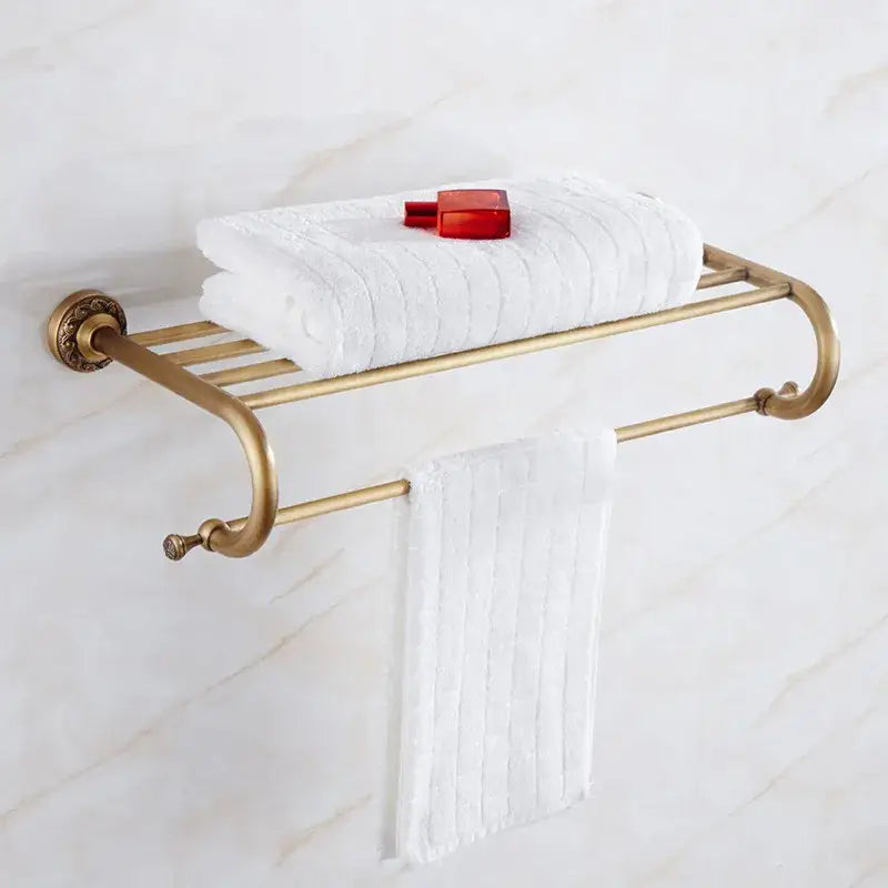 Antique brass bath hardware set featuring a bathroom towel rack with curved arms and decorative end caps by decorbites brass antique