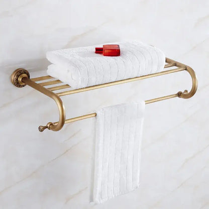 Antique brass bath hardware set featuring a bathroom towel rack with curved arms and decorative end caps by decorbites brass antique