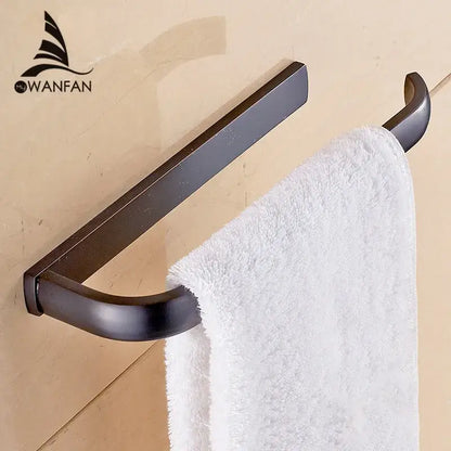 Bronze-finished metal towel rack holding white plush towel from decorbites brass bathroom accessories set with towel rings