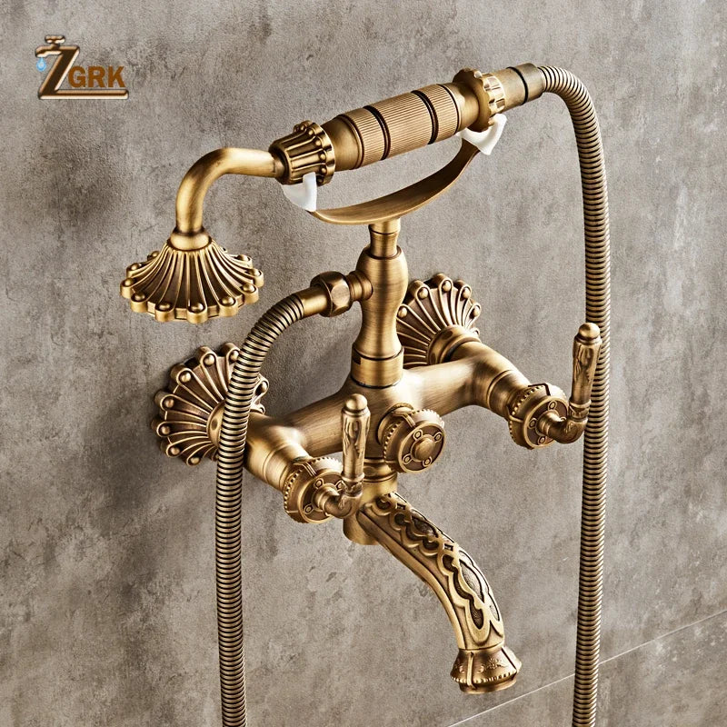 Antique brass bathtub shower set with vintage-style faucet, ornate shell-shaped handles, and decorative scrollwork